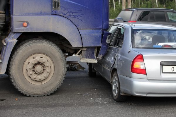 Collision of the truck and car on a busy road